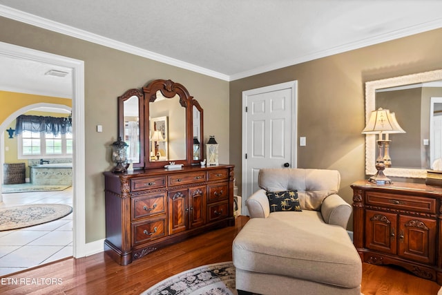 sitting room with crown molding and dark hardwood / wood-style floors