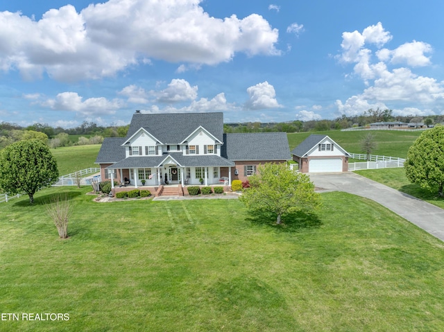 view of front of property with a garage, covered porch, and a front lawn