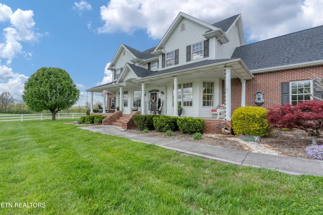 view of front of house featuring a front lawn and covered porch