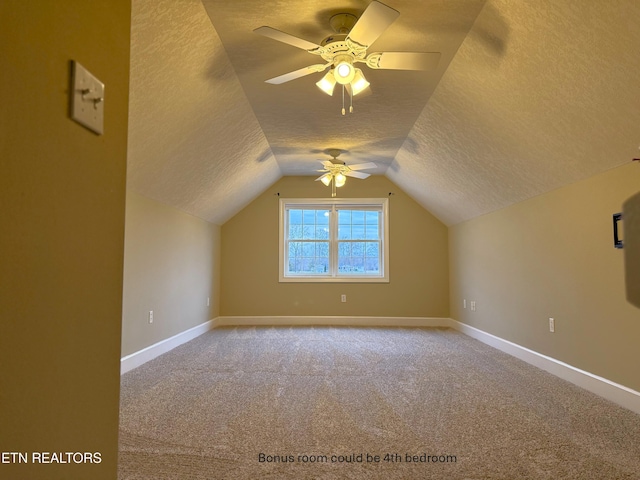 bonus room featuring lofted ceiling, ceiling fan, a textured ceiling, and carpet