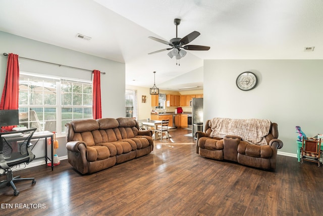 living room with ceiling fan, lofted ceiling, and dark hardwood / wood-style flooring