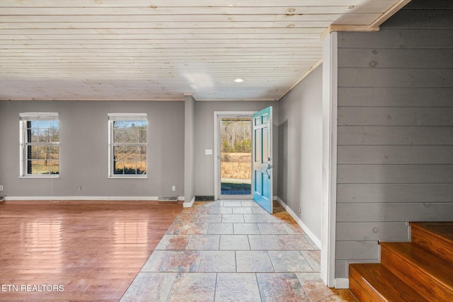 entrance foyer featuring wood ceiling and plenty of natural light