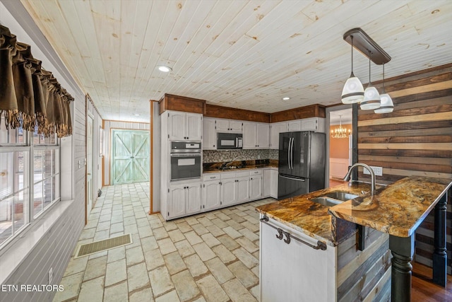 kitchen with black appliances, sink, white cabinets, hanging light fixtures, and kitchen peninsula