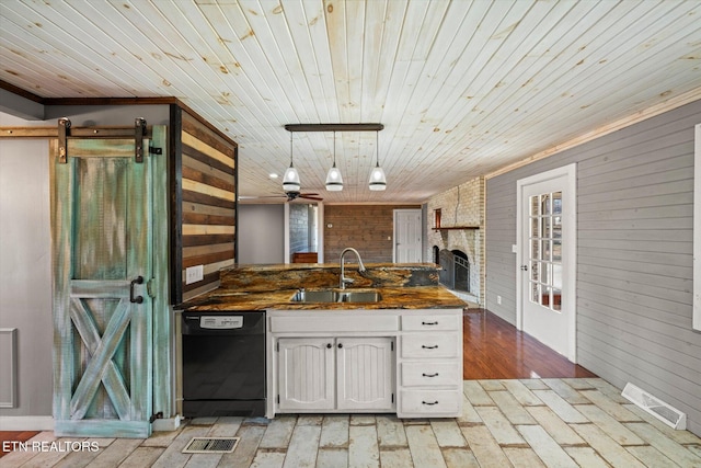 kitchen featuring wood walls, white cabinetry, black dishwasher, sink, and wood ceiling