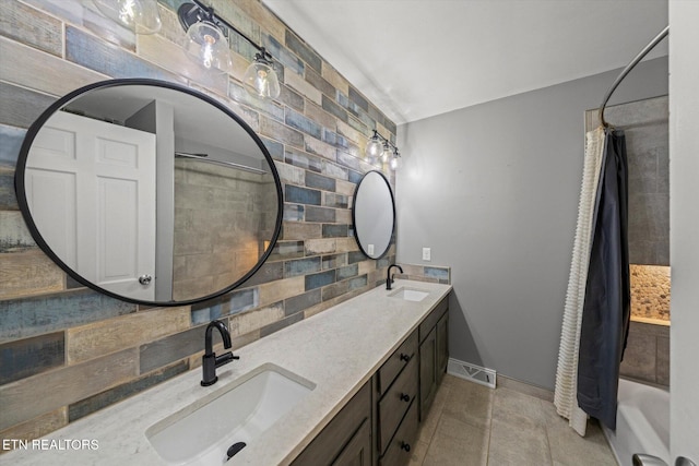 bathroom with vanity, backsplash, and shower / bath combo with shower curtain