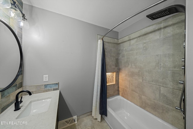 bathroom featuring vanity and shower / bath combo