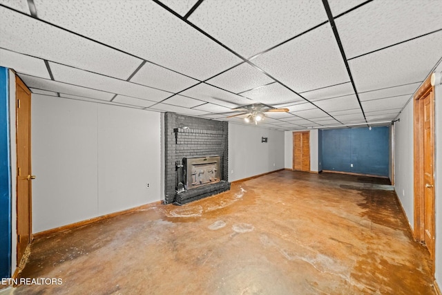 basement featuring a drop ceiling and a fireplace