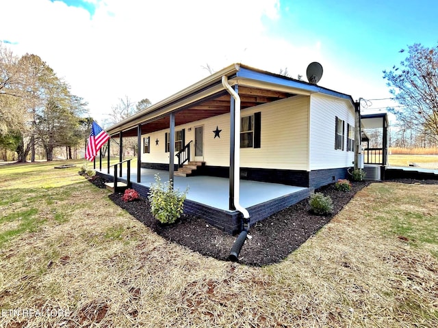 view of side of home featuring a lawn