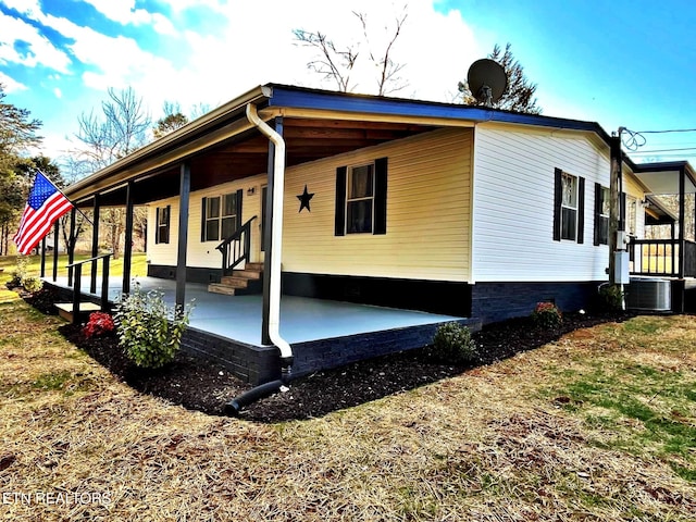 view of side of home featuring a patio and central air condition unit