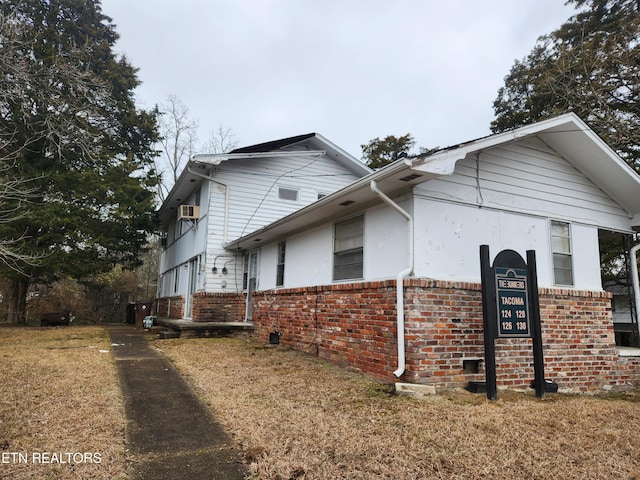 view of side of home featuring a yard