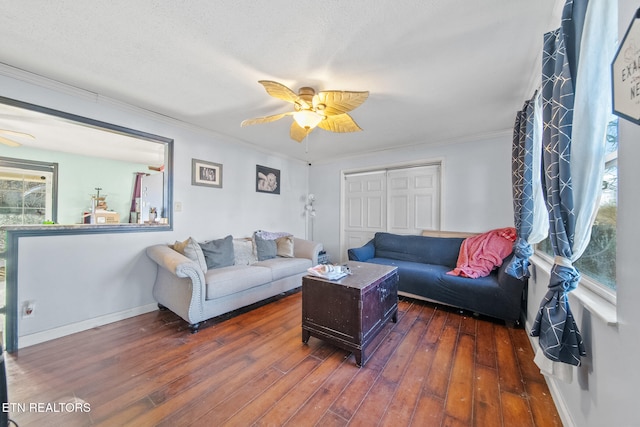 living room featuring ceiling fan, crown molding, and dark hardwood / wood-style flooring