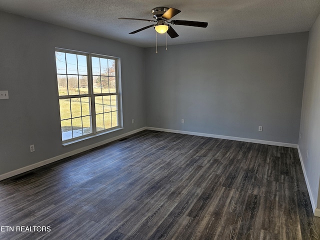 unfurnished room featuring dark wood-type flooring, ceiling fan, and a textured ceiling