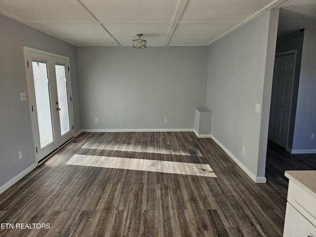 empty room with french doors, plenty of natural light, and dark hardwood / wood-style floors