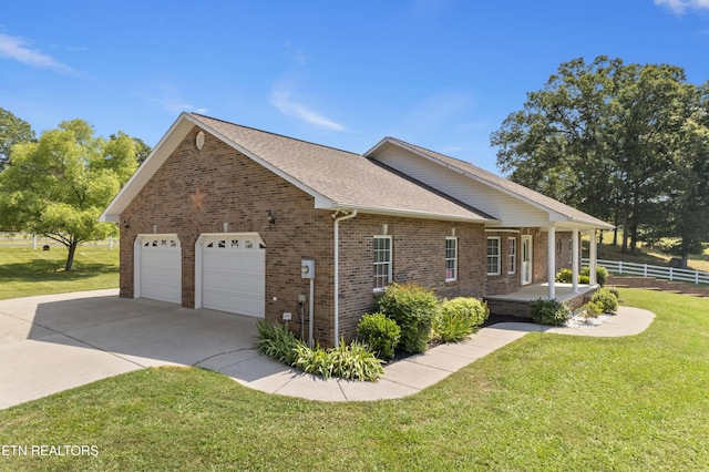 view of property exterior featuring covered porch, a lawn, and a garage