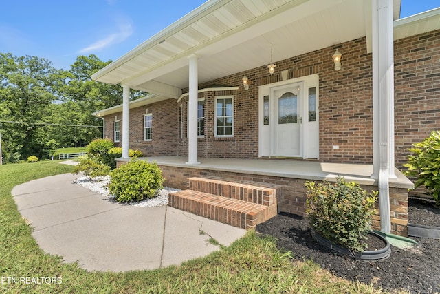 doorway to property featuring covered porch