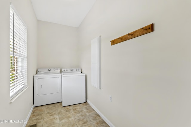 washroom featuring light tile patterned flooring and washing machine and dryer