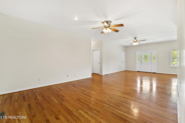 unfurnished living room featuring hardwood / wood-style floors and ceiling fan