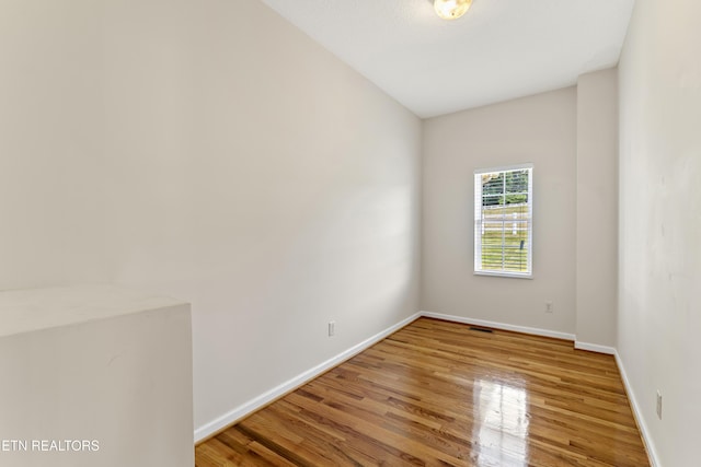 unfurnished room with hardwood / wood-style floors