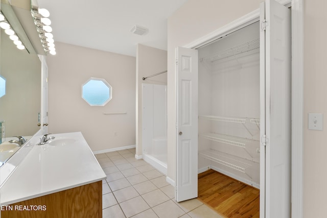 bathroom featuring a shower, tile patterned floors, and vanity