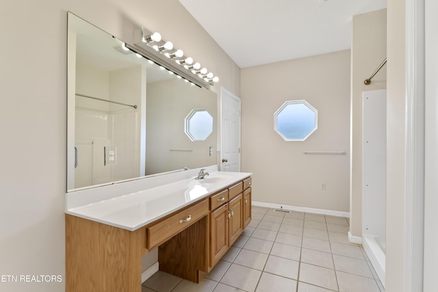 bathroom featuring a shower, vanity, and tile patterned flooring