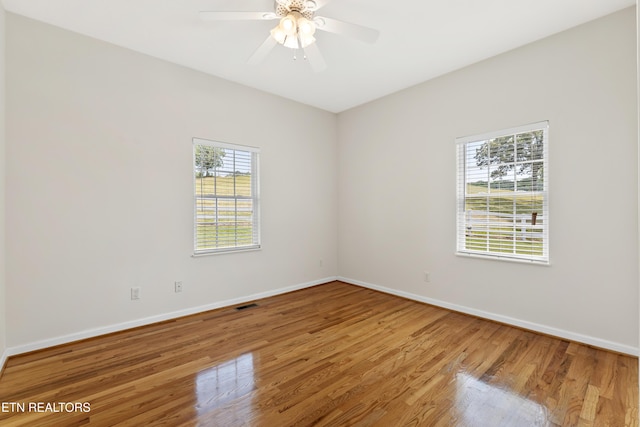 spare room featuring hardwood / wood-style floors, plenty of natural light, and ceiling fan