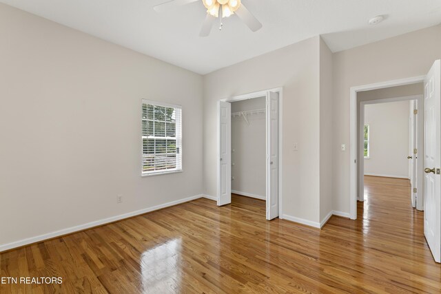 unfurnished bedroom featuring a closet, ceiling fan, and light hardwood / wood-style flooring