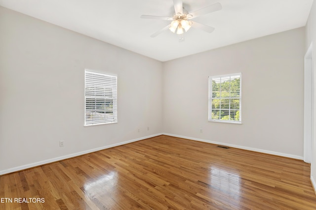 spare room with ceiling fan and wood-type flooring