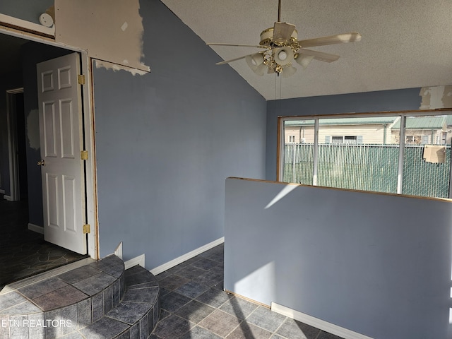 interior space with vaulted ceiling and a textured ceiling