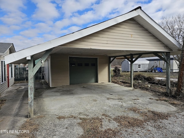 view of parking / parking lot featuring a garage and a carport