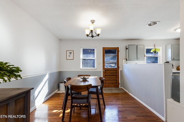 dining area featuring an inviting chandelier and hardwood / wood-style flooring