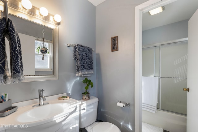 bathroom featuring vanity, toilet, and an enclosed shower