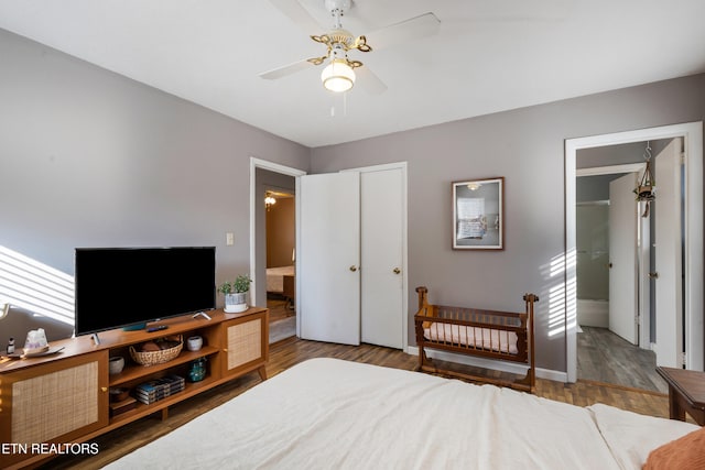 bedroom featuring wood-type flooring, ceiling fan, and a closet