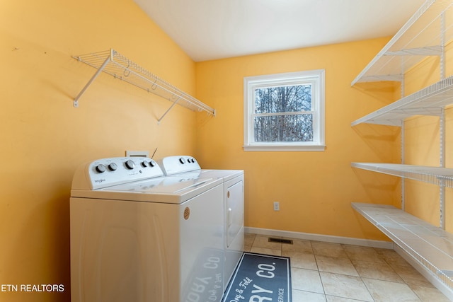 laundry room with tile patterned floors and washer and dryer