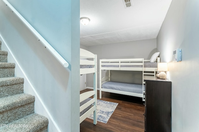 bedroom with dark wood-type flooring