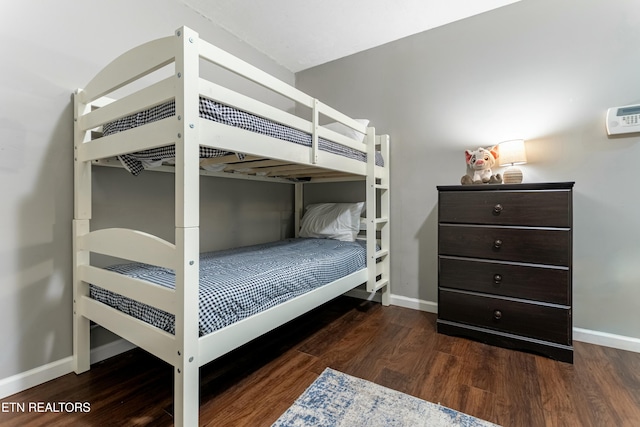 bedroom with dark hardwood / wood-style flooring