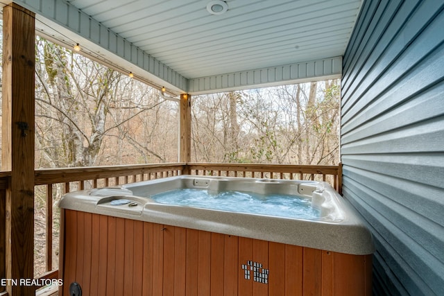 wooden terrace featuring a hot tub