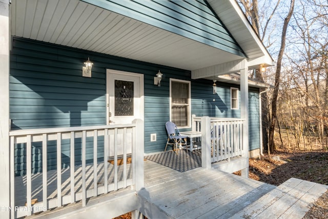 view of exterior entry with a wooden deck