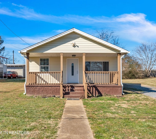 bungalow-style house with covered porch and a front yard