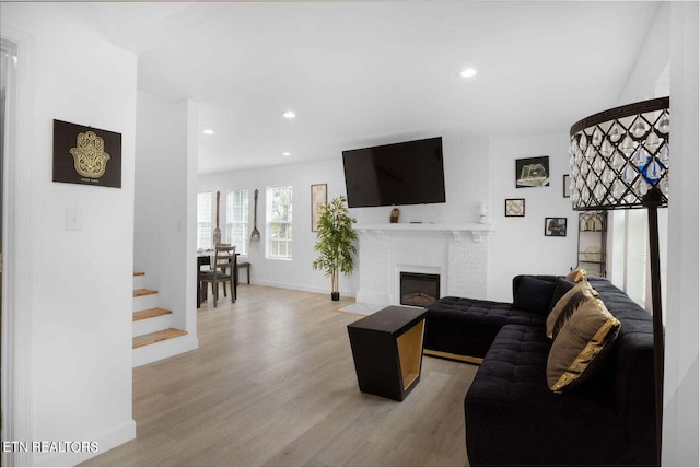 living room with a fireplace and light hardwood / wood-style floors