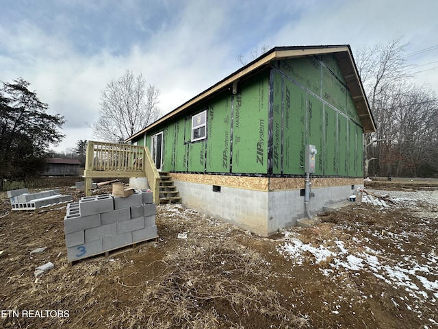 view of snowy exterior featuring a wooden deck