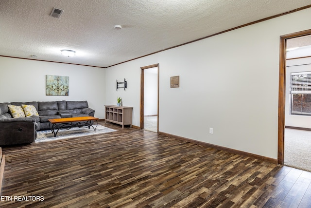 living room with crown molding, dark hardwood / wood-style floors, and a textured ceiling