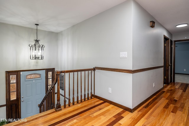 entryway featuring hardwood / wood-style floors and a chandelier