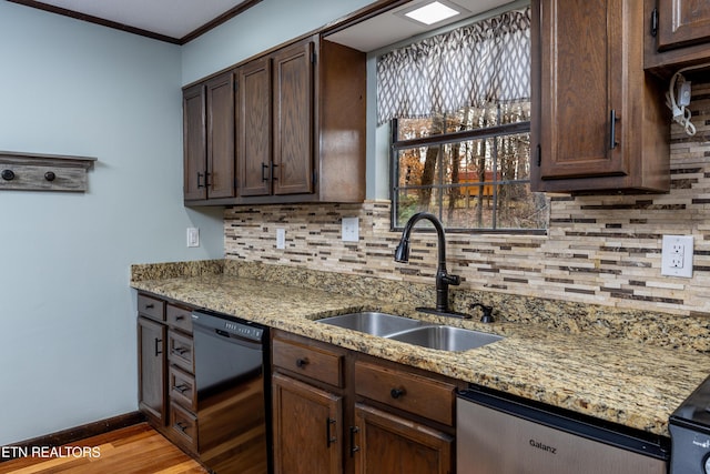 kitchen with dishwasher, dark brown cabinets, and sink