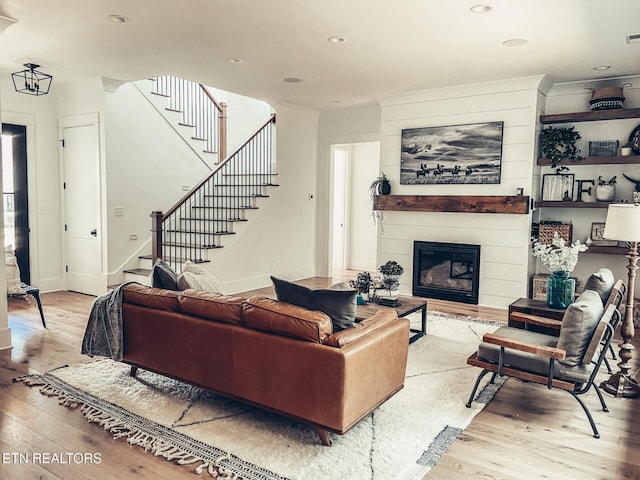 living room with a fireplace and light hardwood / wood-style flooring