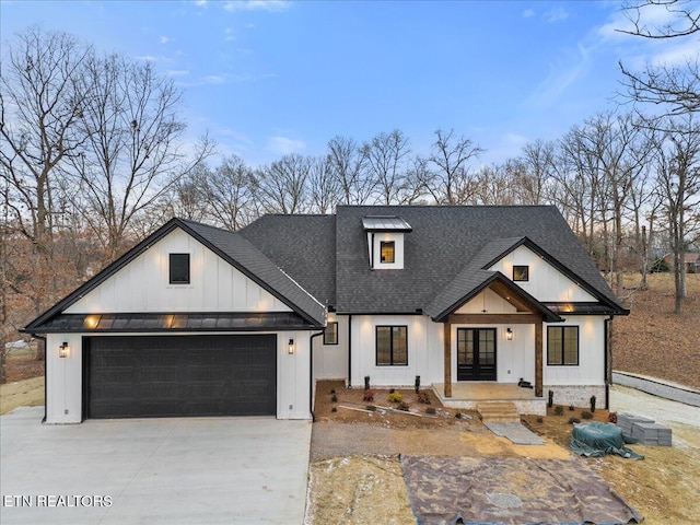 modern inspired farmhouse with a garage