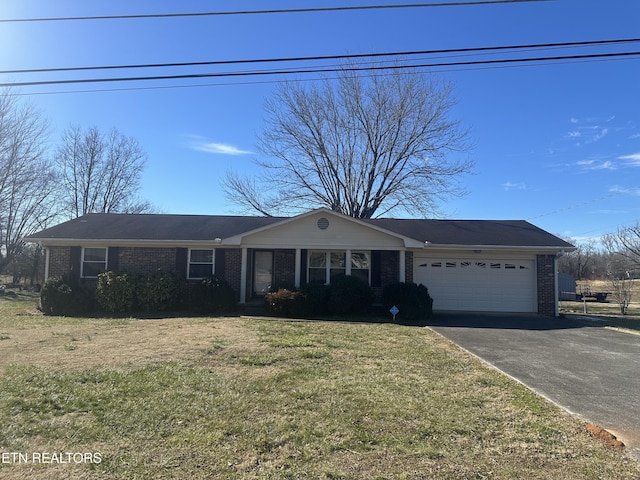 ranch-style house with a garage and a front lawn