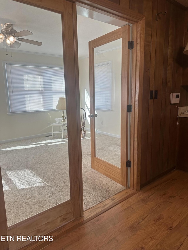 interior space with french doors, ceiling fan, crown molding, and hardwood / wood-style flooring