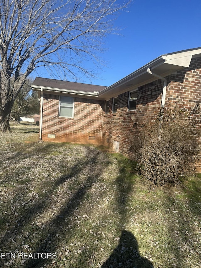 view of side of property with a yard