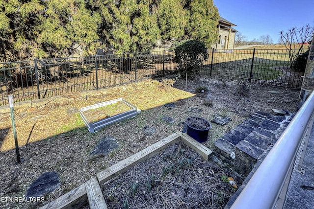 view of yard with a garden and fence