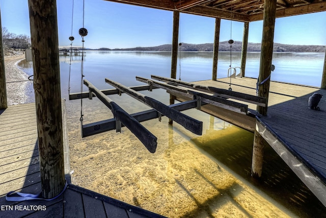 view of dock with a water view and boat lift